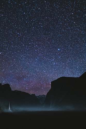 night silhouette of mountains during starry night astronomy